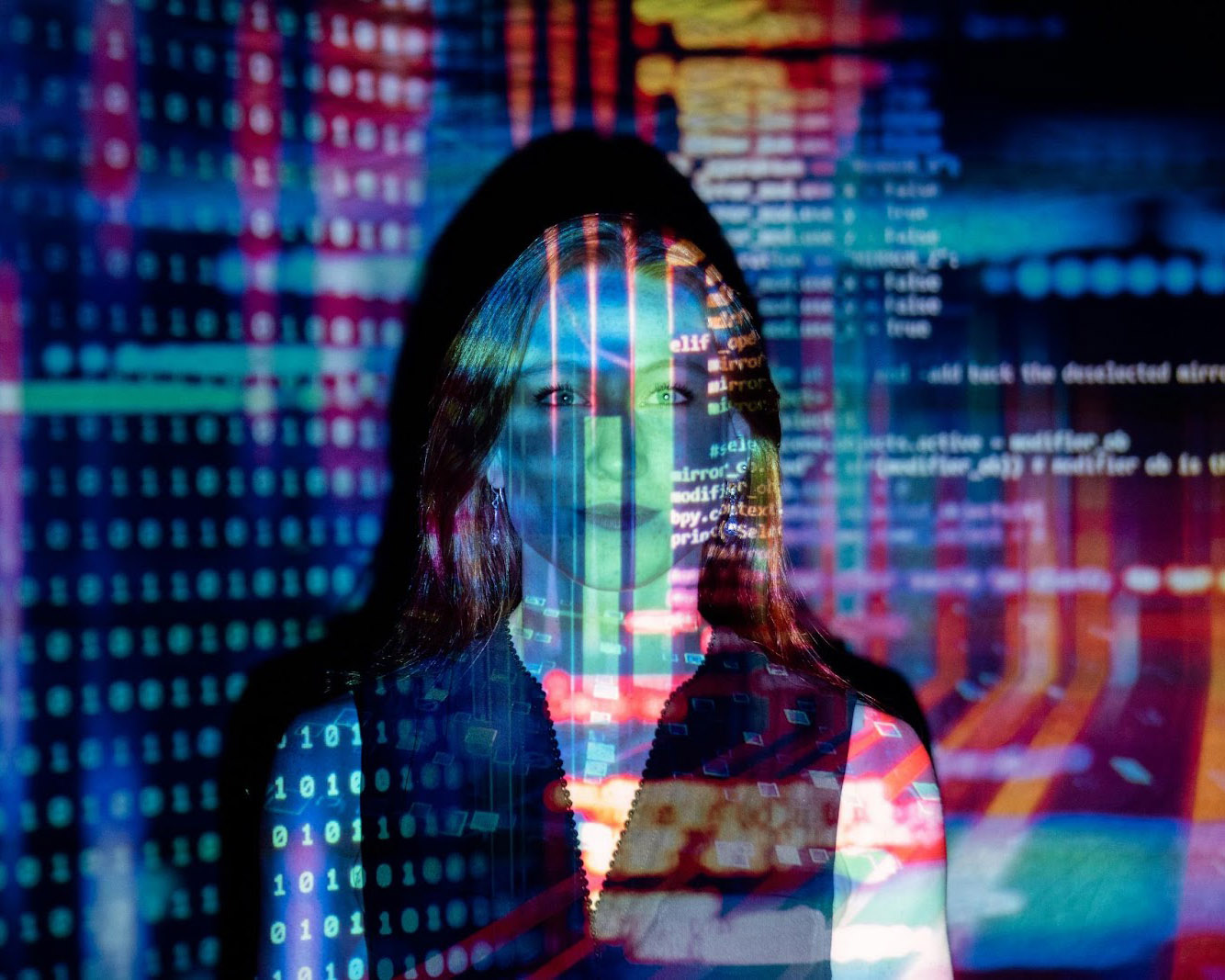 Woman with large colorful data projection on background.